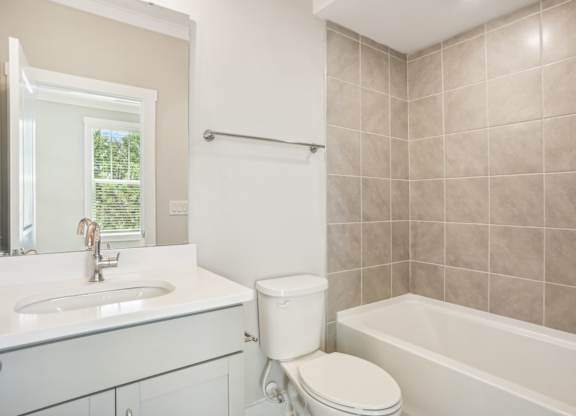 a bathroom with a sink toilet and a bath tub
