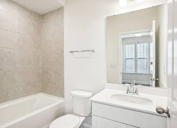 a bathroom with a sink toilet and a mirror