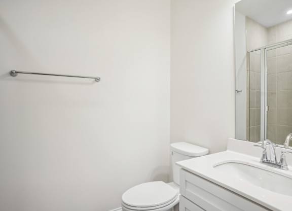 a bathroom with a sink toilet and a mirror
