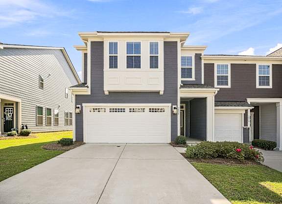 A two-story house with a garage is shown in the image.