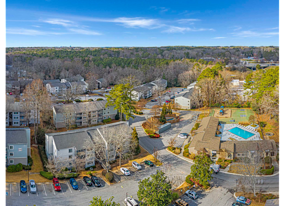 Bird’s-eye view of Springdale Glen in Clarkston, GA, near Decatur, highlighting the community’s residential buildings, pool, and landscaped grounds.