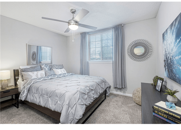 Bedroom with large windows at Springdale Glen, a pet-friendly community in Clarkston, GA, near Decatur.