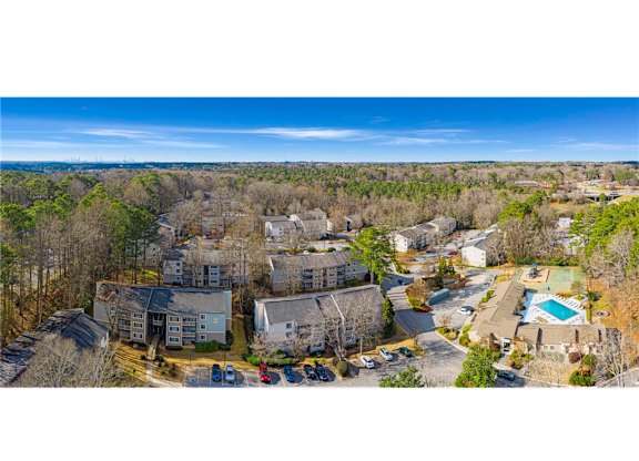 Aerial view of Springdale Glen, a pet-friendly community in Clarkston, GA, near Decatur, showcasing the layout of buildings and amenities.