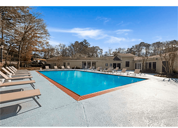 Resort-inspired pool with lounge chairs at Springdale Glen, a pet-friendly community in Clarkston, GA, near Decatur.
