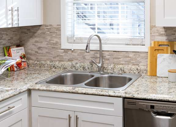 A kitchen with a sink and a window.