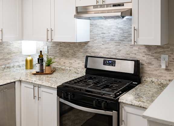 A modern kitchen with a black stove top oven.