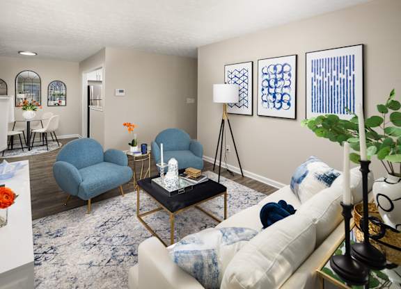 A living room with a blue chair and a white couch.