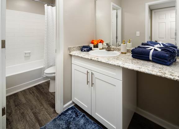 A bathroom with a white toilet, a white sink, and a white bathtub.