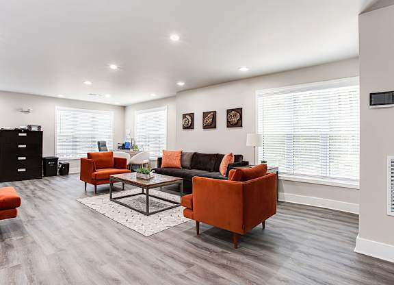 A living room with a grey floor and white walls.