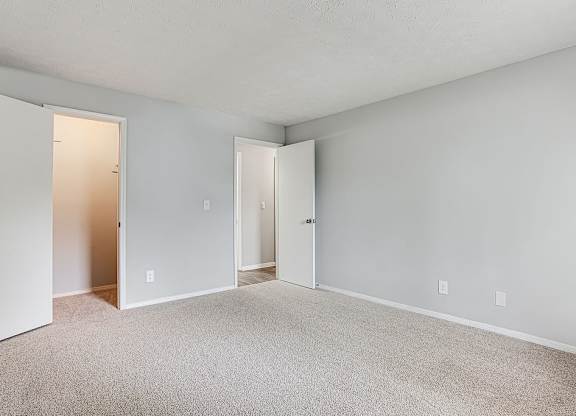 A room with carpeted floor and white walls.