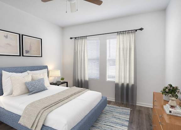 A bedroom with a bed, nightstand, and a ceiling fan.