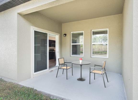 A patio with a table and chairs is shown.