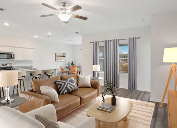 A living room with a brown leather couch and a wooden coffee table.