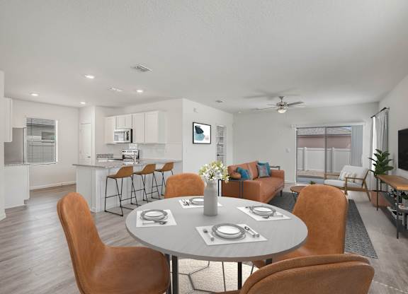 A modern dining room with a round table and chairs.