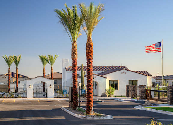 an flag flies in front of a building with palm trees