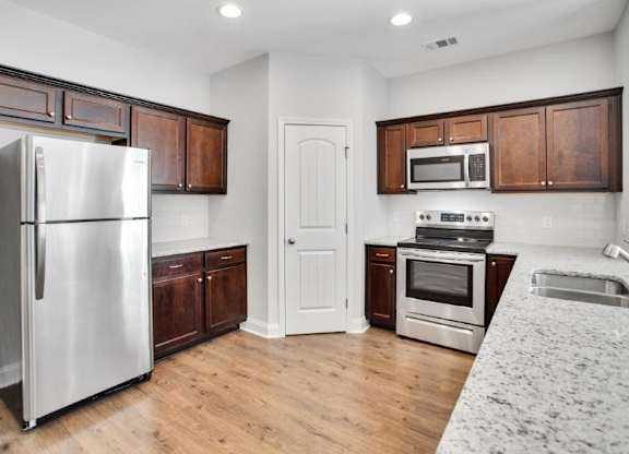Harris Trail Luxury Townhomes for rent Richmond Hill, GA photo of kitchen with pantry and exspresso cabinets