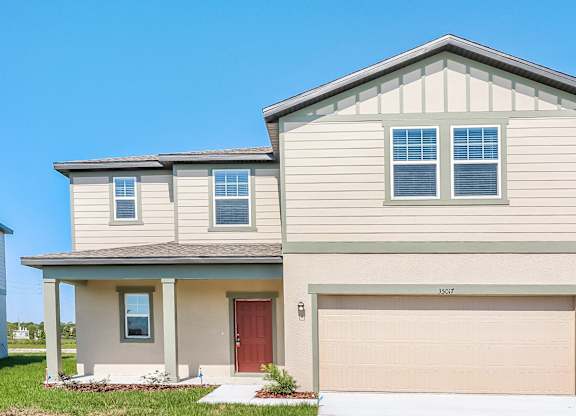 A two-story house with a red door and garage door.