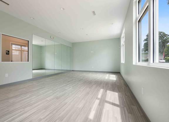 Spacious multipurpose room with wall mirrors at Hunters Pointe apartments in Charlotte, NC 28213, near UNC Charlotte.