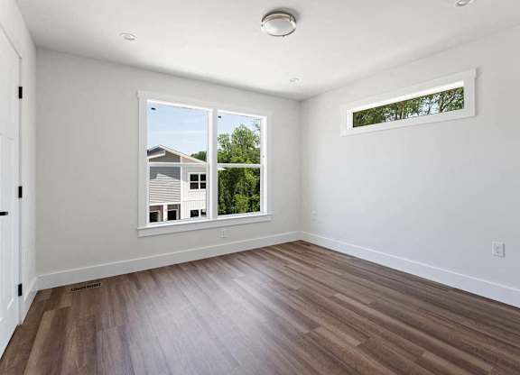 A room with a window and a door.
