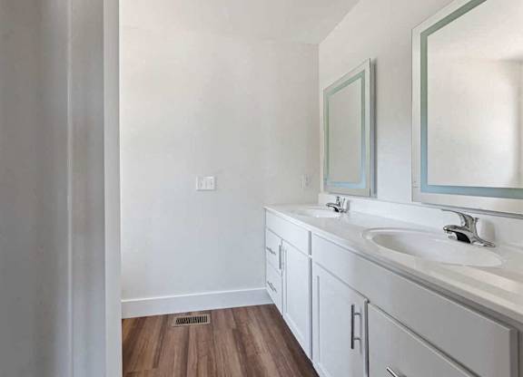 A bathroom with a white sink and a mirror.