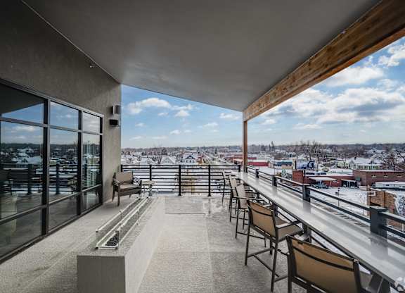 Luxury Apartments for Rent in Greeley CO - The Shelby - Rooftop Balcony with Fire Pit, Seating, Wooden Design Details, and City Views
