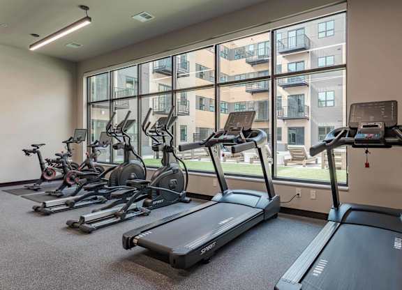 A gym with treadmills and exercise bikes.