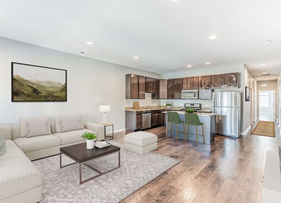 a living room and kitchen with a couch and a table