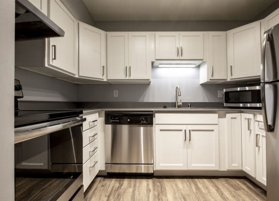 updated kitchen with stainless steel appliances and counter tops