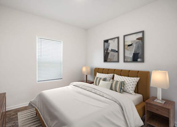 A bedroom with a bed, nightstands, and two framed pictures on the wall.