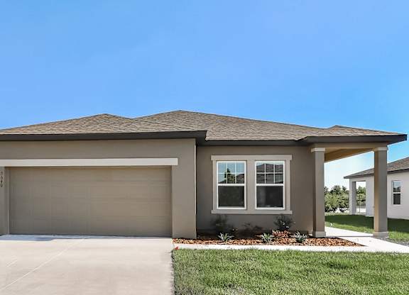 A house with a garage door and a window.