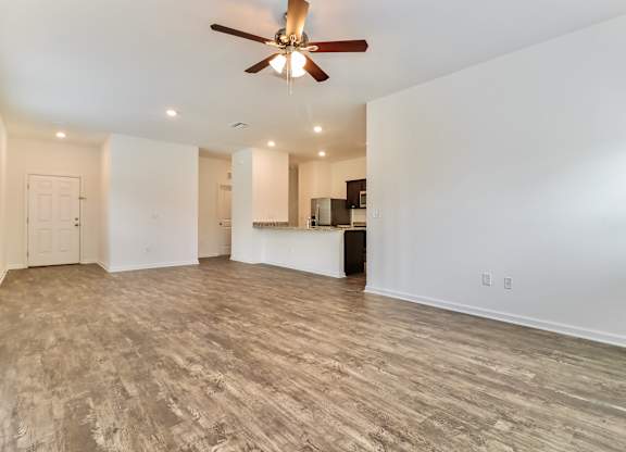 A room with a ceiling fan and lighting fixtures.