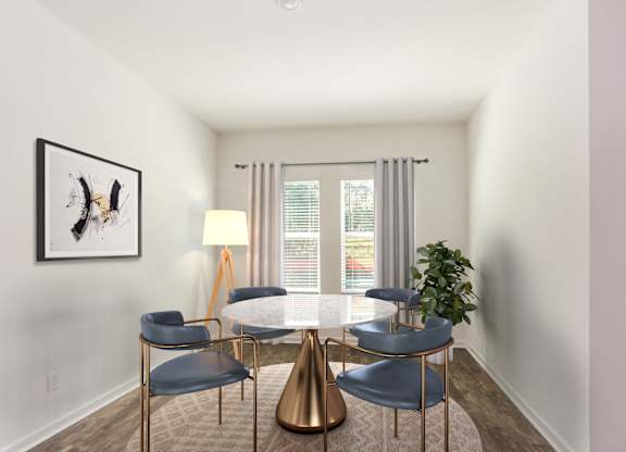 A modern dining room with a gold table and chairs.