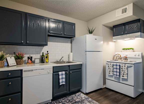 Kitchen with white appliances and ample cabinet space at Mableton Ridge Apartments in Mableton, GA, near Douglasville.