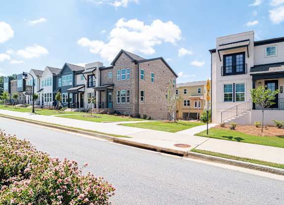 A row of houses with a street in front.