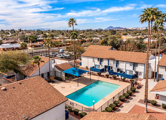 Community overview featuring pool and palm trees at Midtown on Seneca, a pet-friendly apartment community near East Central Tucson, Tucson, AZ.