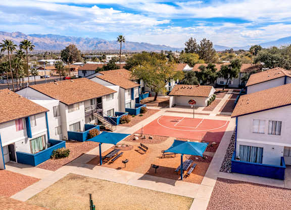 Aerial view of Midtown on Seneca showing outdoor grilling stations, shaded picnic lounge, and full-sized basketball court at this pet-friendly apartment community near East Central Tucson, Tucson, AZ.