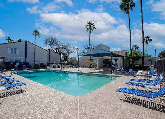 Swimming pool with outdoor seating at Midtown on Seneca, a pet-friendly apartment community near East Central Tucson, Tucson, AZ