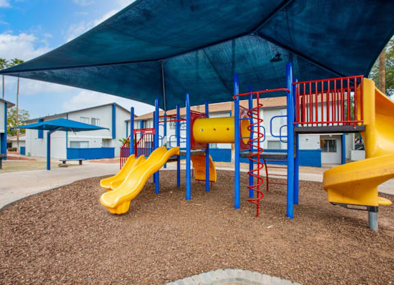 Family-friendly playground with modern equipment at Midtown on Seneca, a pet-friendly apartment community near East Central Tucson, Tucson, AZ.