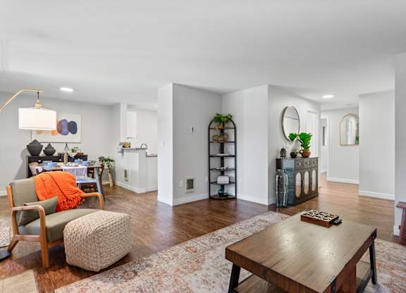 A living room with a brown table and a chair at MonteVista Apartments, Beaverton, OR