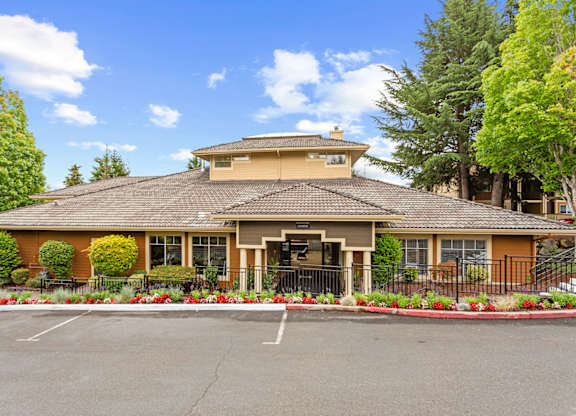 A building with a brown roof and a black gate in front at MonteVista Apartments, Beaverton, Oregon