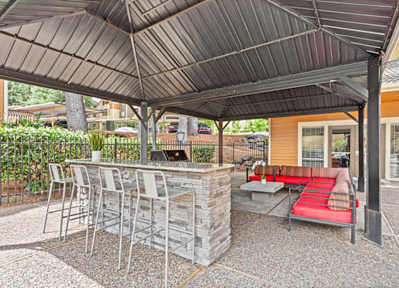 A patio with a bar and chairs under a roof at MonteVista Apartments, Beaverton, OR 97007