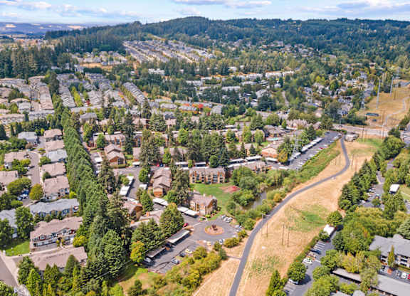A bird's eye view of a residential area with houses and trees at MonteVista Apartments, Oregon 97007