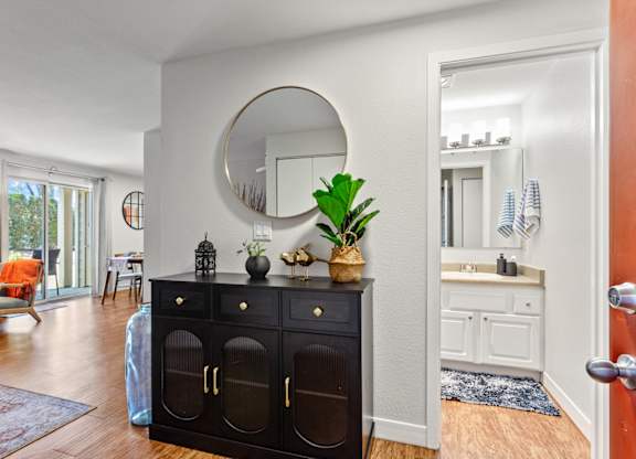 A black dresser with a mirror above it in a room at MonteVista Apartments, Beaverton, 97007