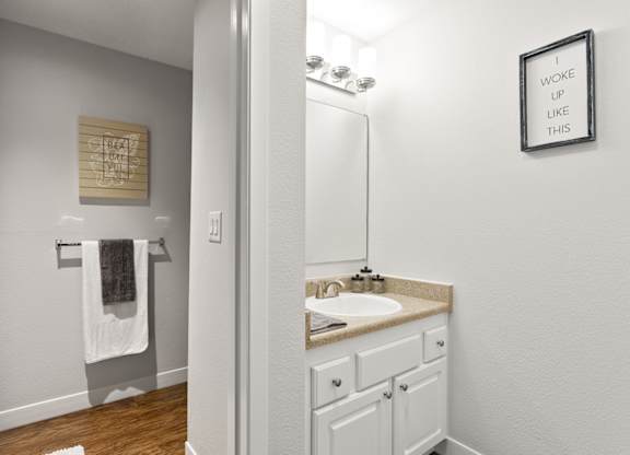 A bathroom with a white sink and a mirror at MonteVista Apartments, Oregon