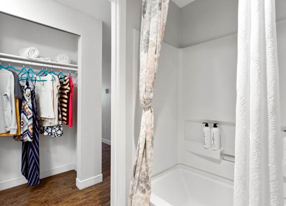 A white bathroom with a white tub and a white shower curtain at MonteVista Apartments, Beaverton, 97007