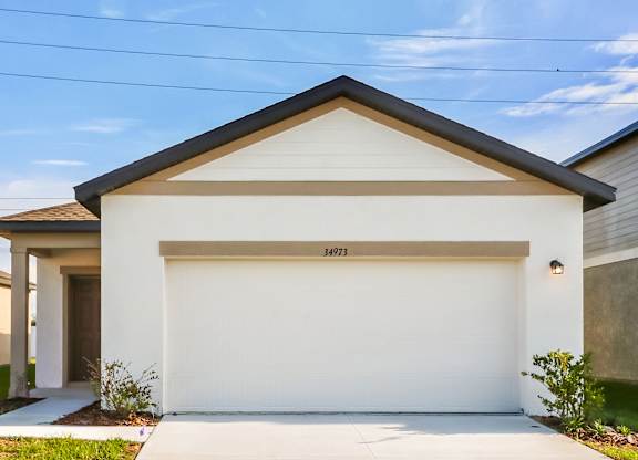 A white garage door with the number 34973 on it.