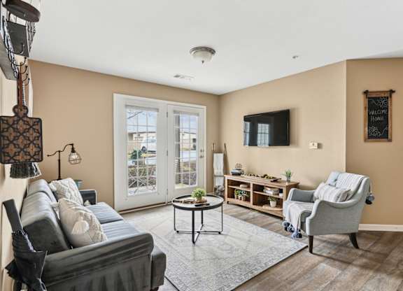 Pet-Friendly Rentals in Sevierville, TN – Overlook at Allensville – A living room with a grey couch, a coffee table, a chair, and a lamp.
