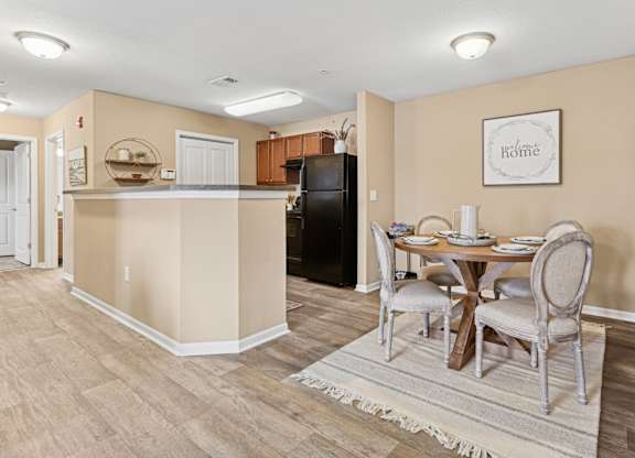 Apartments in Sevierville for Rent – Overlook at Allensville - A kitchen with a table and chairs in the middle of the room.