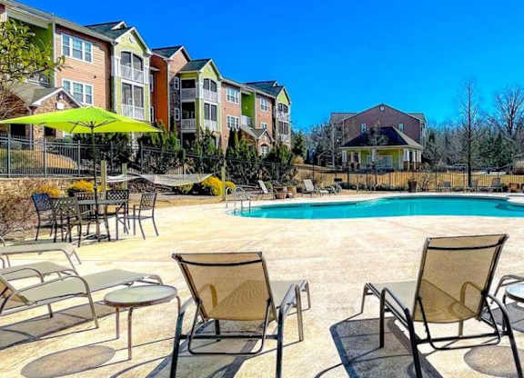 Pet-Friendly Apartments in Opelika, AL – The Crossings of Opelika - swimming pool and sundeck with chairs