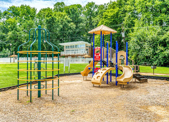 Community playground with safe play structures at Grand Arbor Reserve Apartments in Raleigh, NC 27607, near Central Raleigh